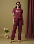 Woman wearing a maroon outfit with text on a beige background